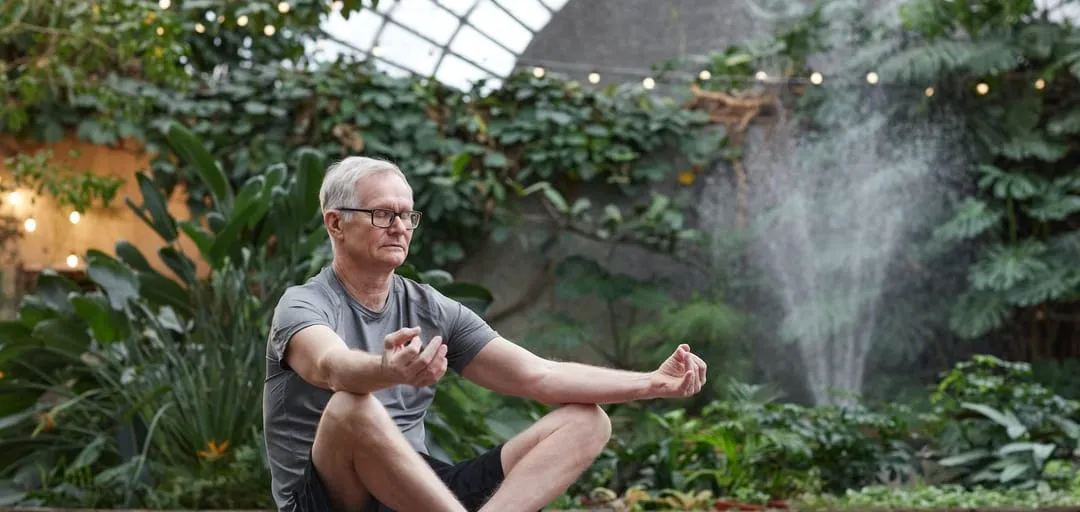 Man meditating in yoga pose.